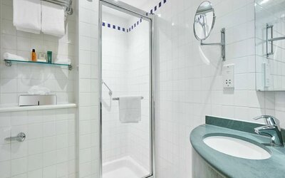 Guest bathroom with shower and toiletries at the Hilton Garden Inn Birmingham Brindleyplace.