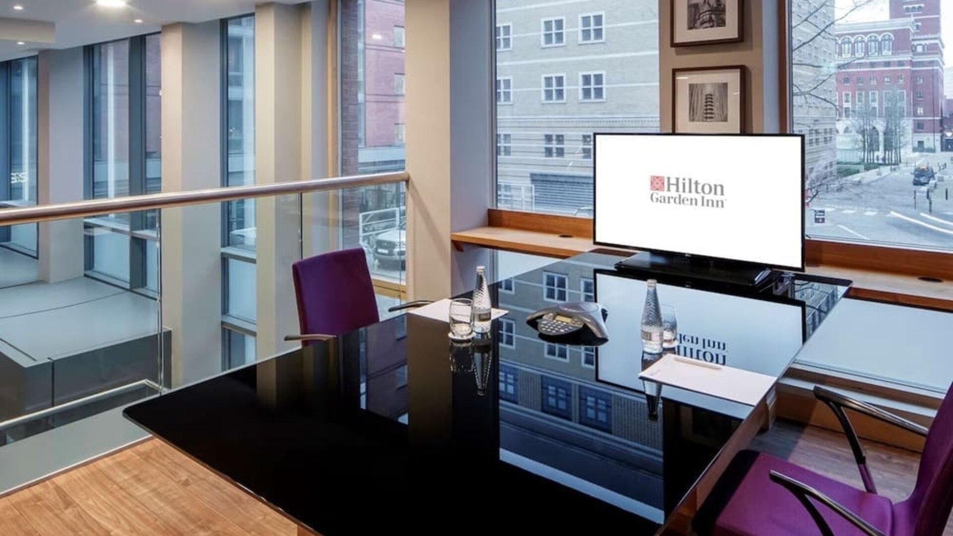 Meeting room with TV and large windows at the Hilton Garden Inn Birmingham Brindleyplace.