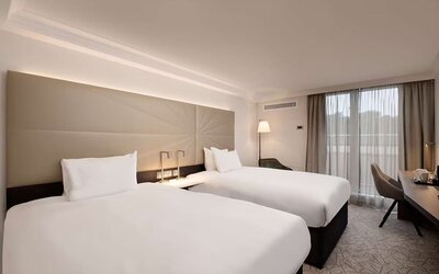 Twin room with work desk and big windows at the Hilton Birmingham Metropole.