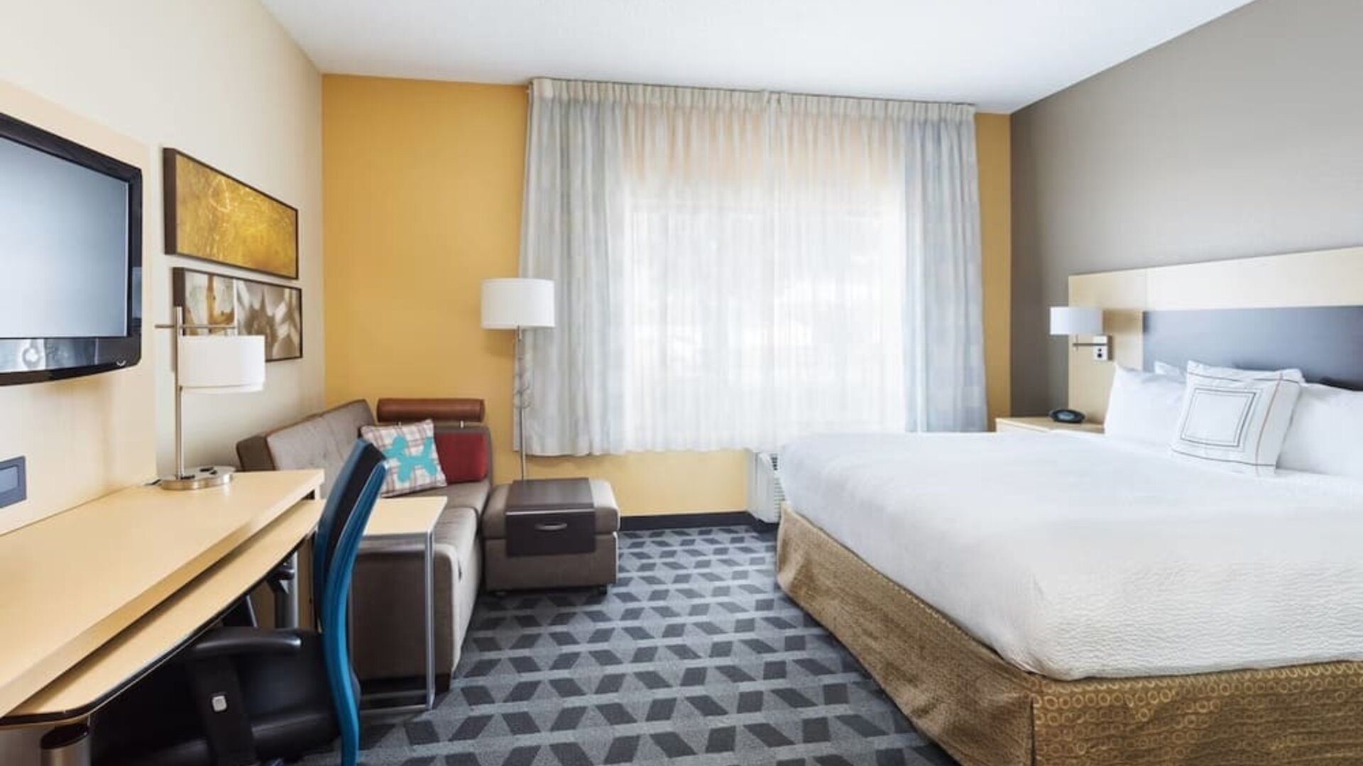 Day use room with work desk and sofa at TownePlace Suites By Marriott Shreveport-Bossier City.