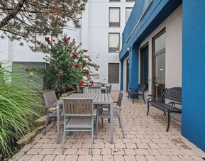 Outdoor patio featuring comfortable seating, landscaped surroundings, and a peaceful space to relax and unwind at Hampton Inn Ridgefield Park.