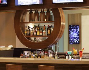 Stylish hotel bar offering a full beverage selection, comfortable seating, and a modern social atmosphere at Crowne Plaza Panama Airport.