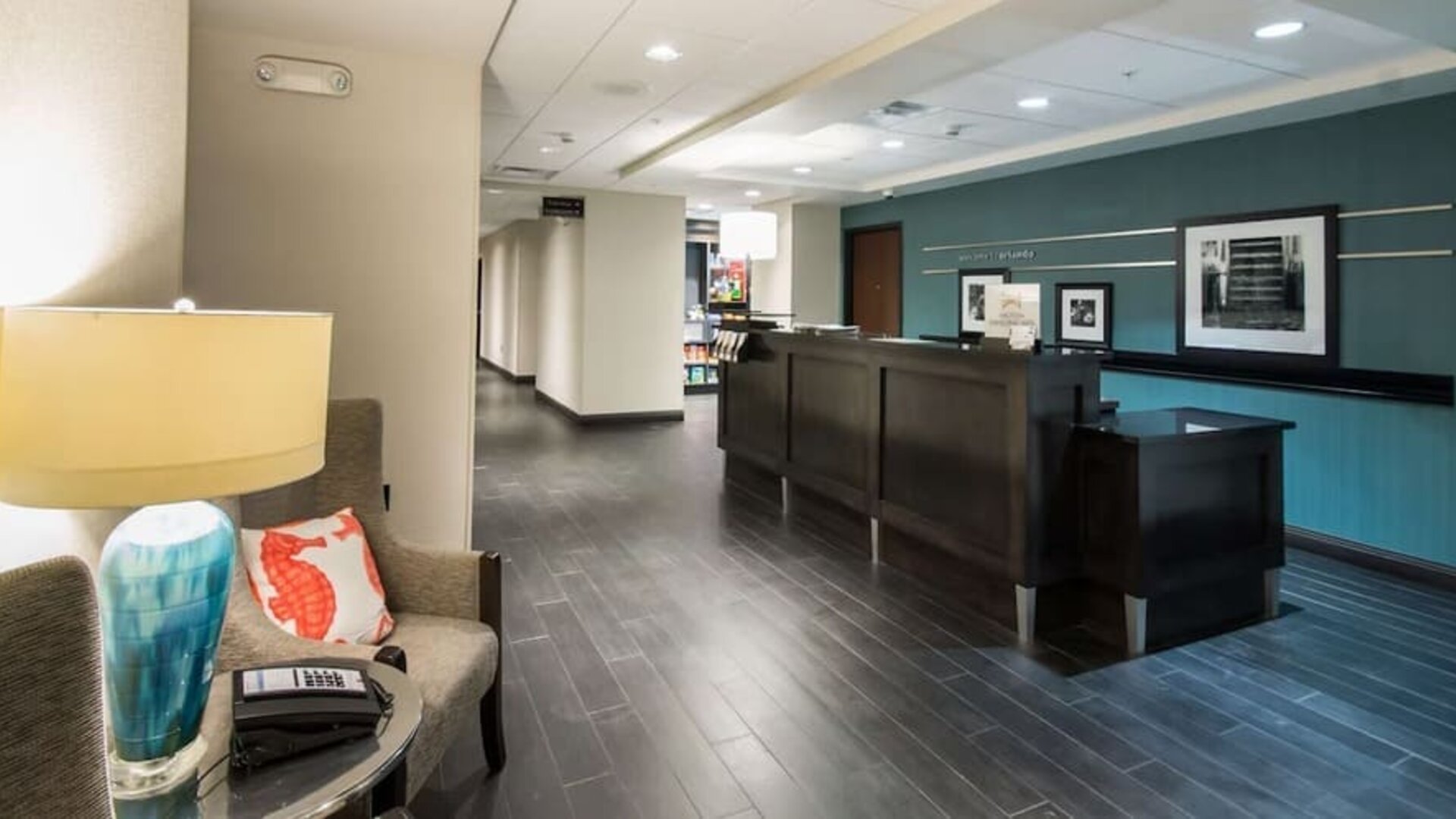 Reception area with front desk, seating, and welcoming lobby at Hampton Inn & Suites Orlando at SeaWorld.