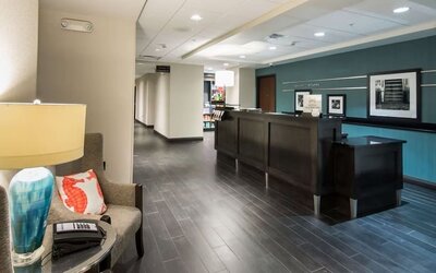 Reception area with front desk, seating, and welcoming lobby at Hampton Inn & Suites Orlando at SeaWorld.