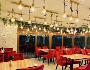 Dining area with stylish lighting, comfortable seating, and modern décor at Stay Inn Express.