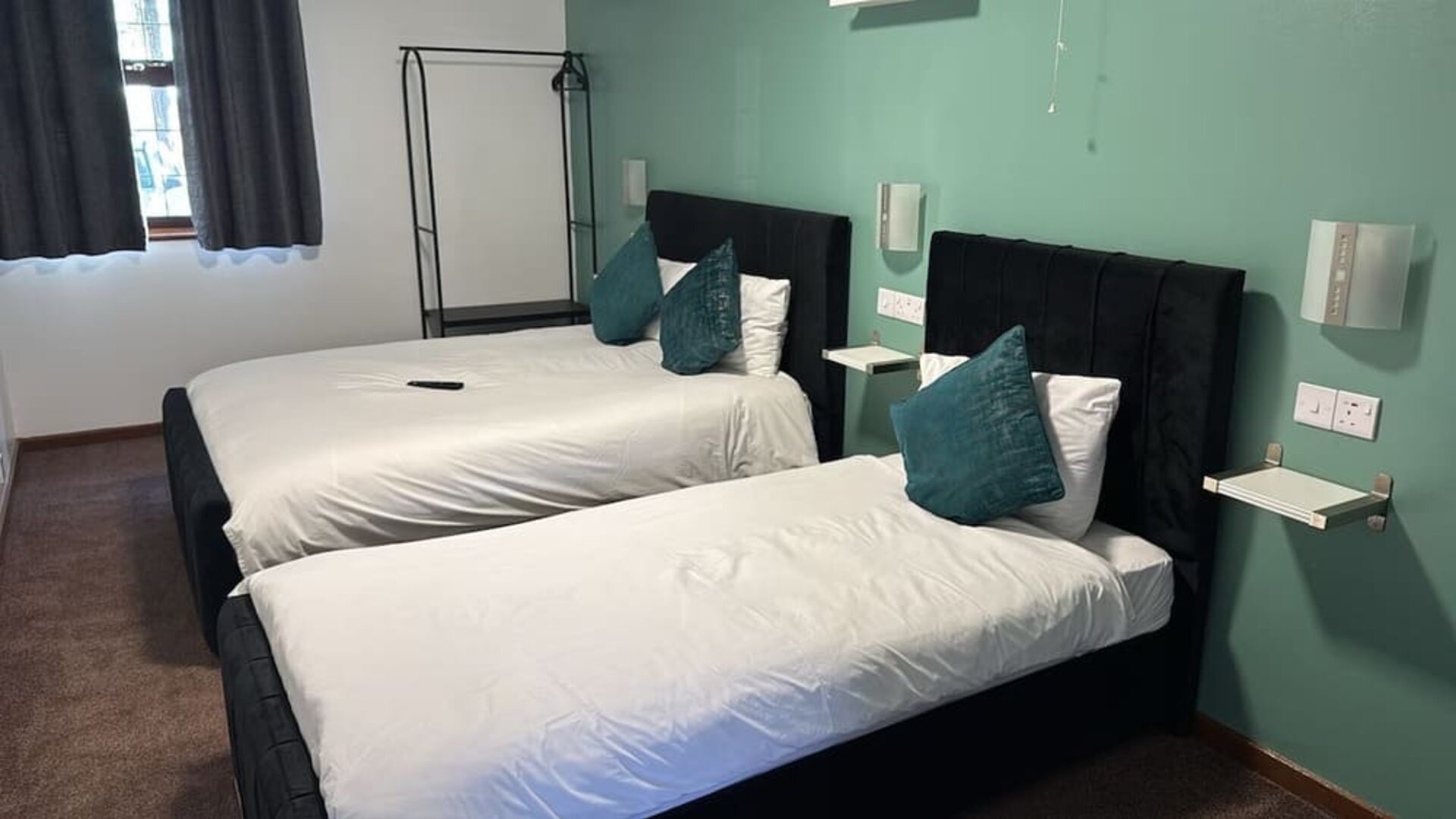 Guest room with two double beds and contemporary décor at Stay Inn Express.