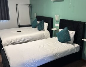 Guest room with two double beds and contemporary décor at Stay Inn Express.