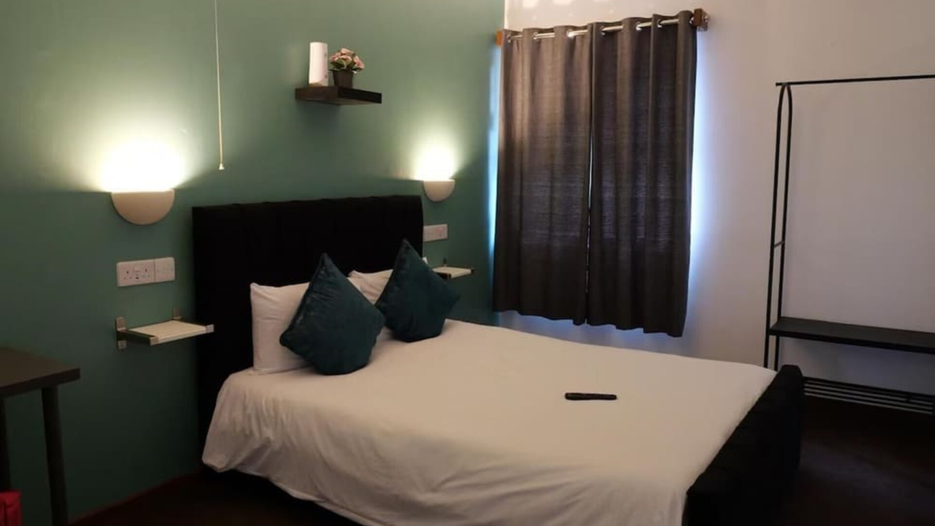 Guest room with double bed, accent wall, and modern furnishings at Stay Inn Express.