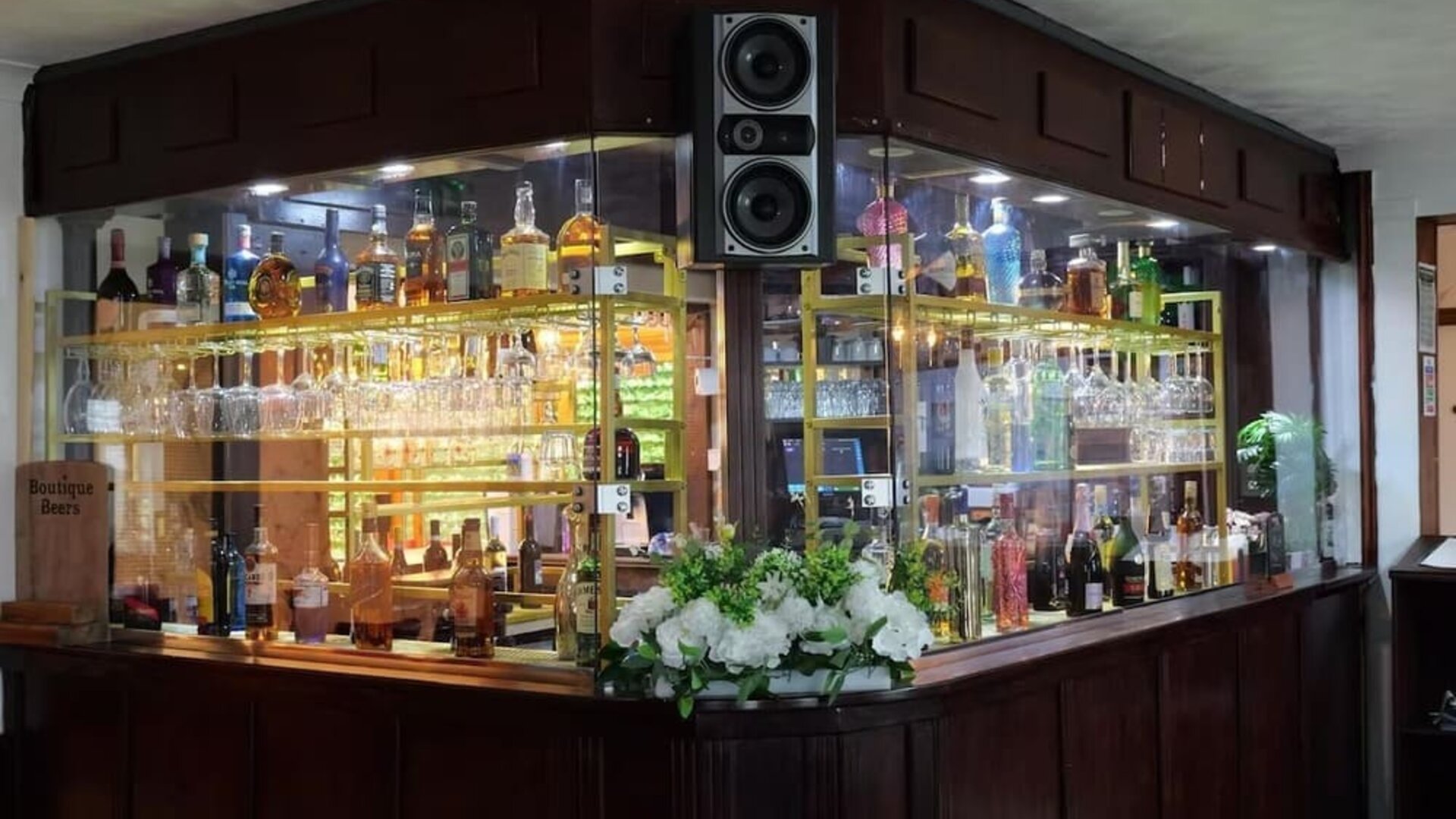 Hotel bar with a selection of spirits, wine, and glassware at Stay Inn Express.
