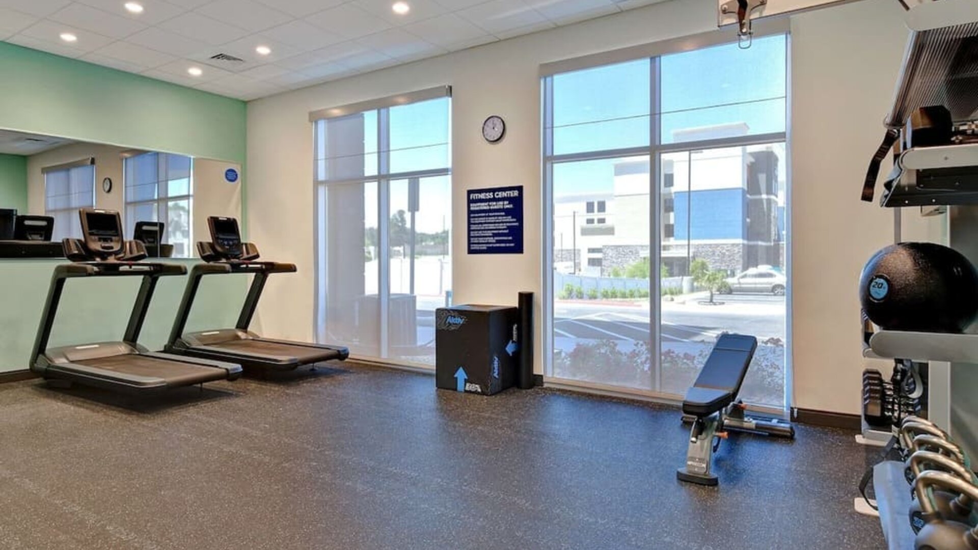 Fitness center with treadmills, free weights, and strength training equipment at Tru By Hilton Lithia Springs.