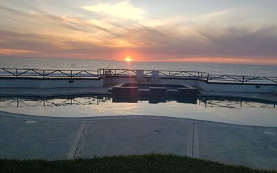 Oceanfront pool at sunset with hot tub and uninterrupted Pacific Ocean views at Casa Playa Baja Resort.