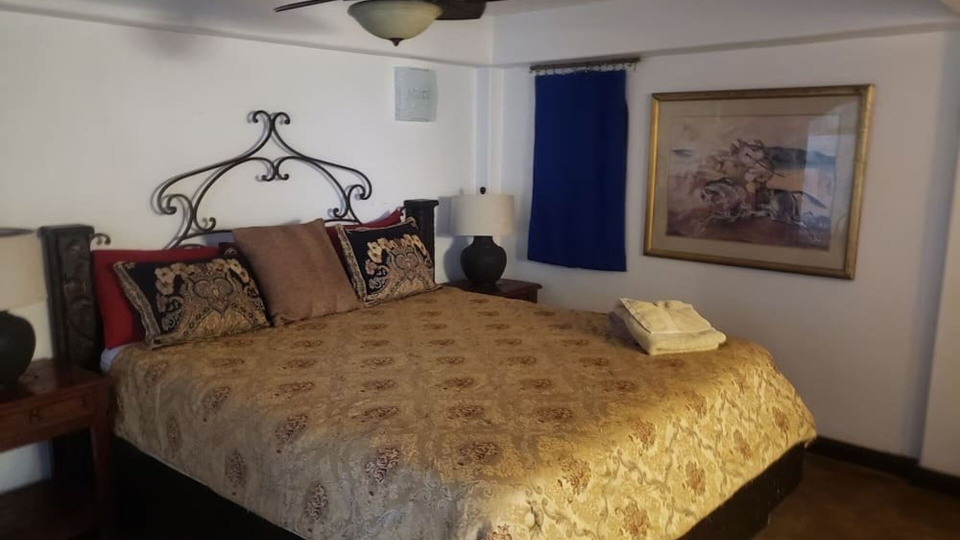 Comfortable guest bedroom with king-size bed, traditional furnishings, and warm rustic accents at Casa Playa Baja Resort.