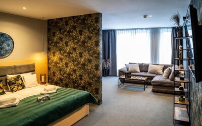 Spacious suite with king-size bed, separate living area and contemporary décor at Hotel Seven.