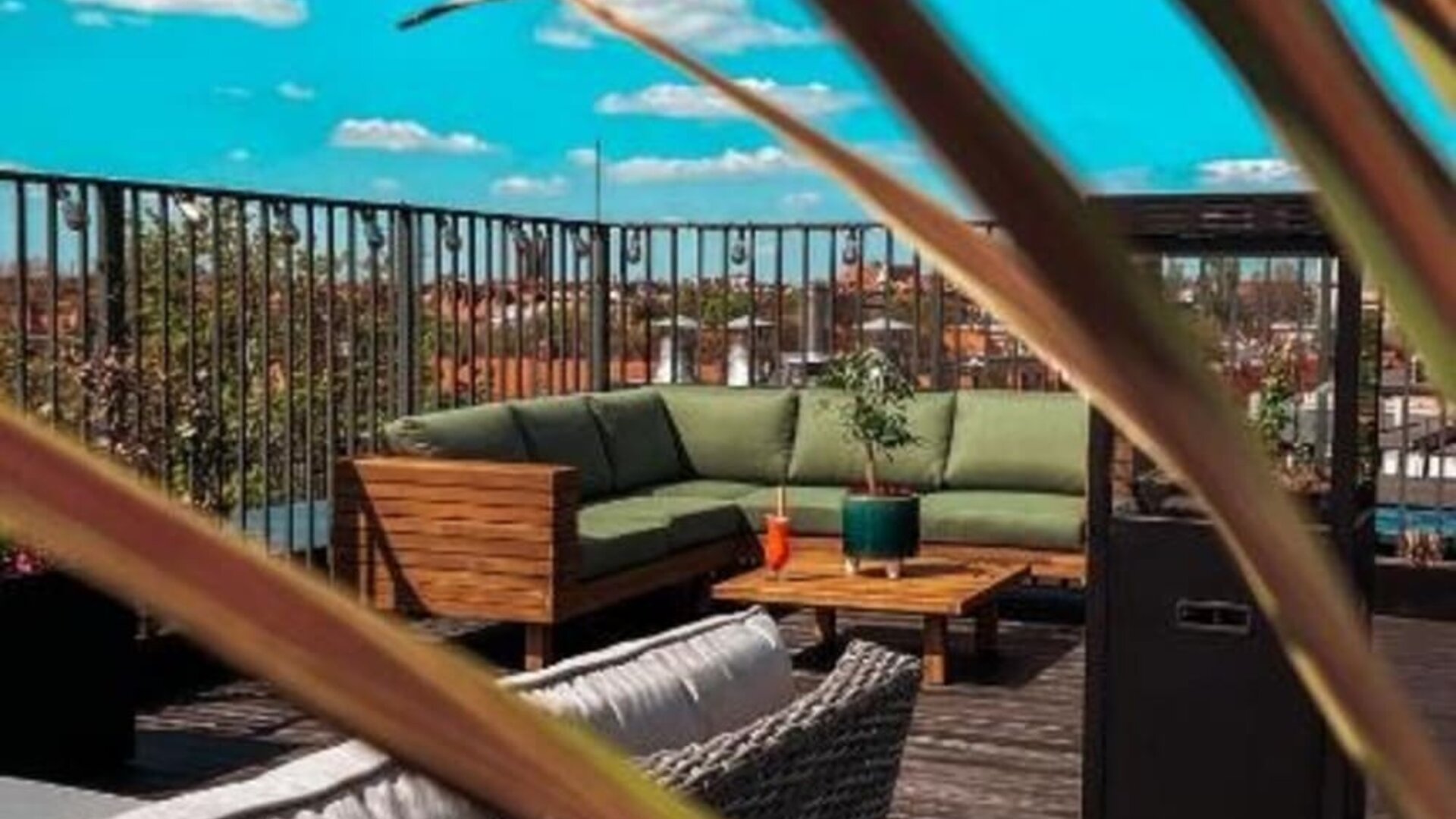 Modern rooftop lounge with outdoor furniture and open-air relaxation space at Hotel Seven.