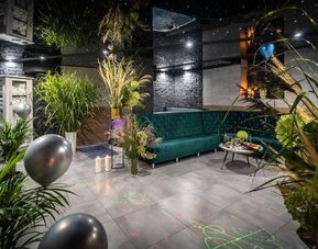 Stylish spa lounge with modern seating, greenery and ambient lighting at Hotel Seven.