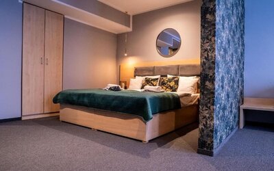 Spacious Hotel Seven bedroom with king-size bed, modern wardrobe and elegant décor.
