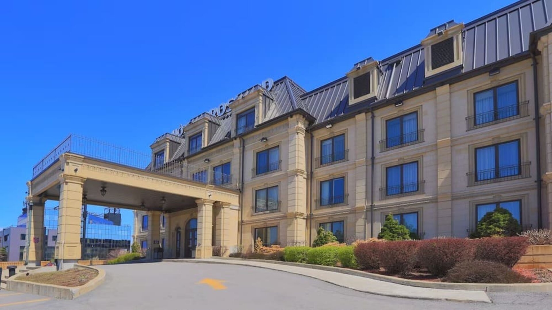 Exterior view of Hotel Brossard showcasing its elegant entrance and classic architecture.
