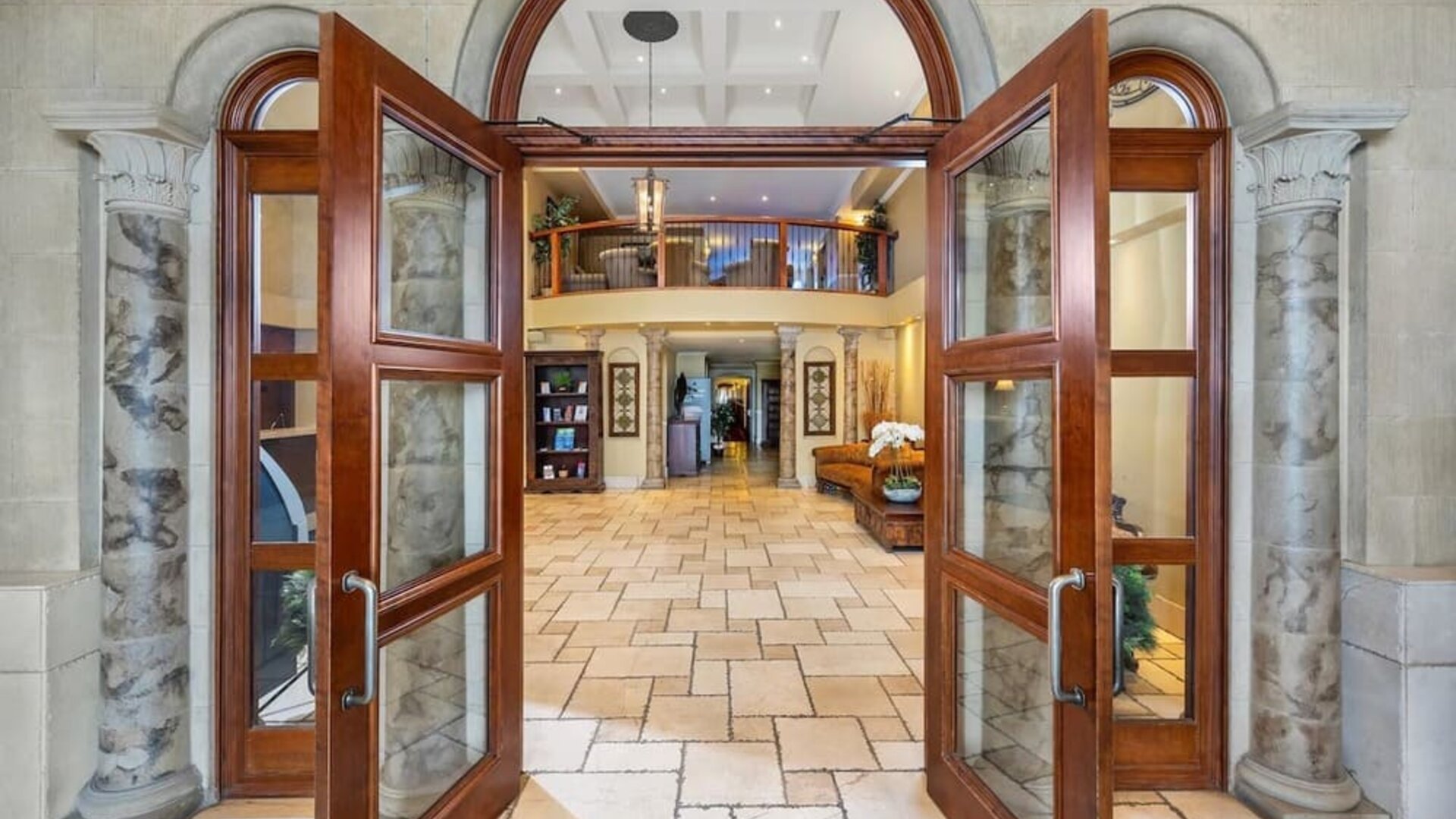 Grand entrance leading into the welcoming hotel lobby at Hotel Brossard.