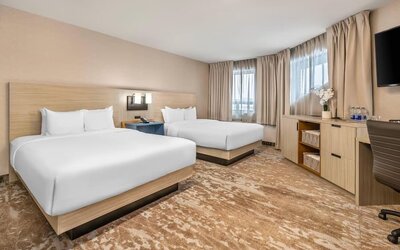Spacious guest room with two queen beds and contemporary furnishings at Comfort Inn Laval.