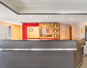 Modern hotel reception desk providing friendly guest services at Comfort Inn Laval.