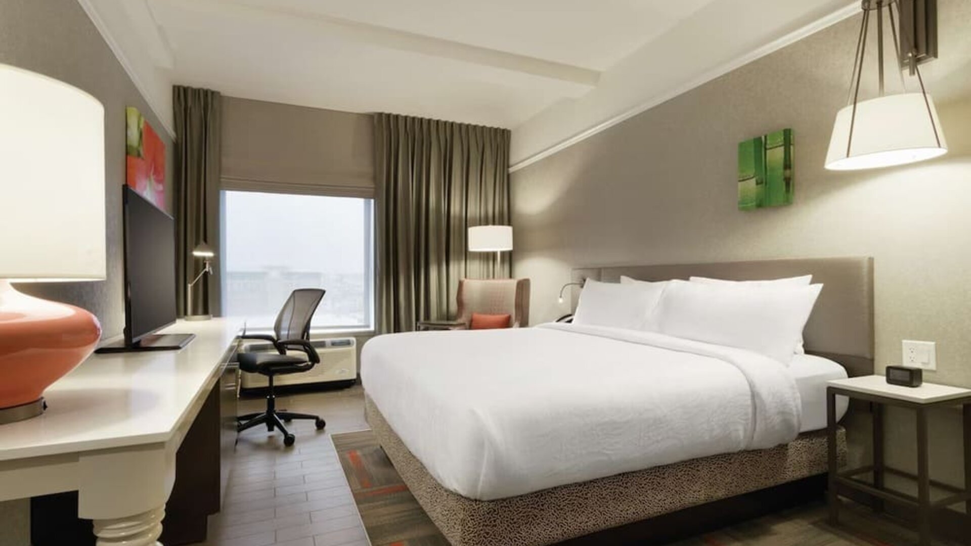 Contemporary king guest room with ergonomic workspace, comfortable seating and modern amenities at Hilton Garden Inn Calgary Downtown.