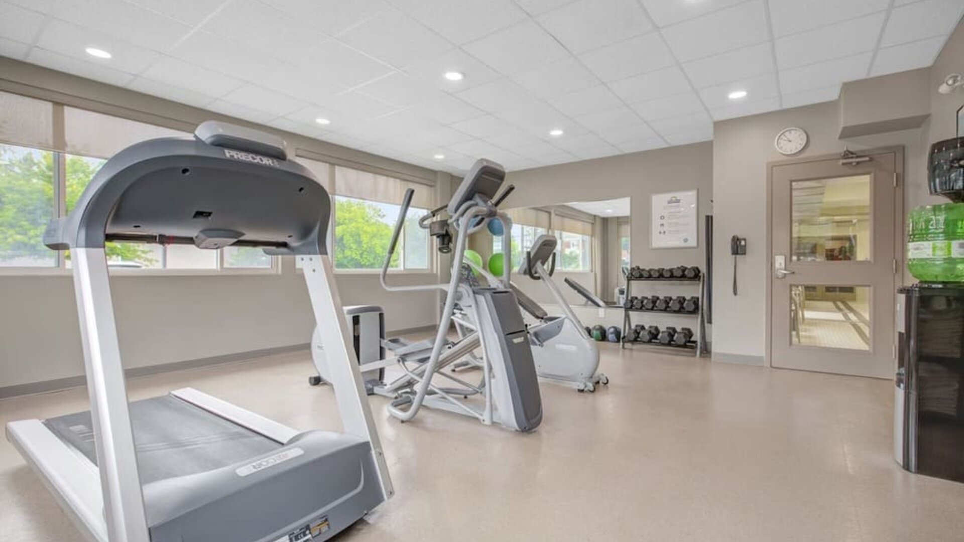 Fitness center featuring cardio equipment, free weights and exercise space at Days Inn & Suites By Wyndham Lindsay.