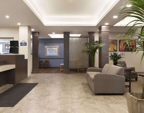 Bright hotel lobby with reception area, comfortable seating and contemporary décor at Days Inn & Suites By Wyndham Lindsay.