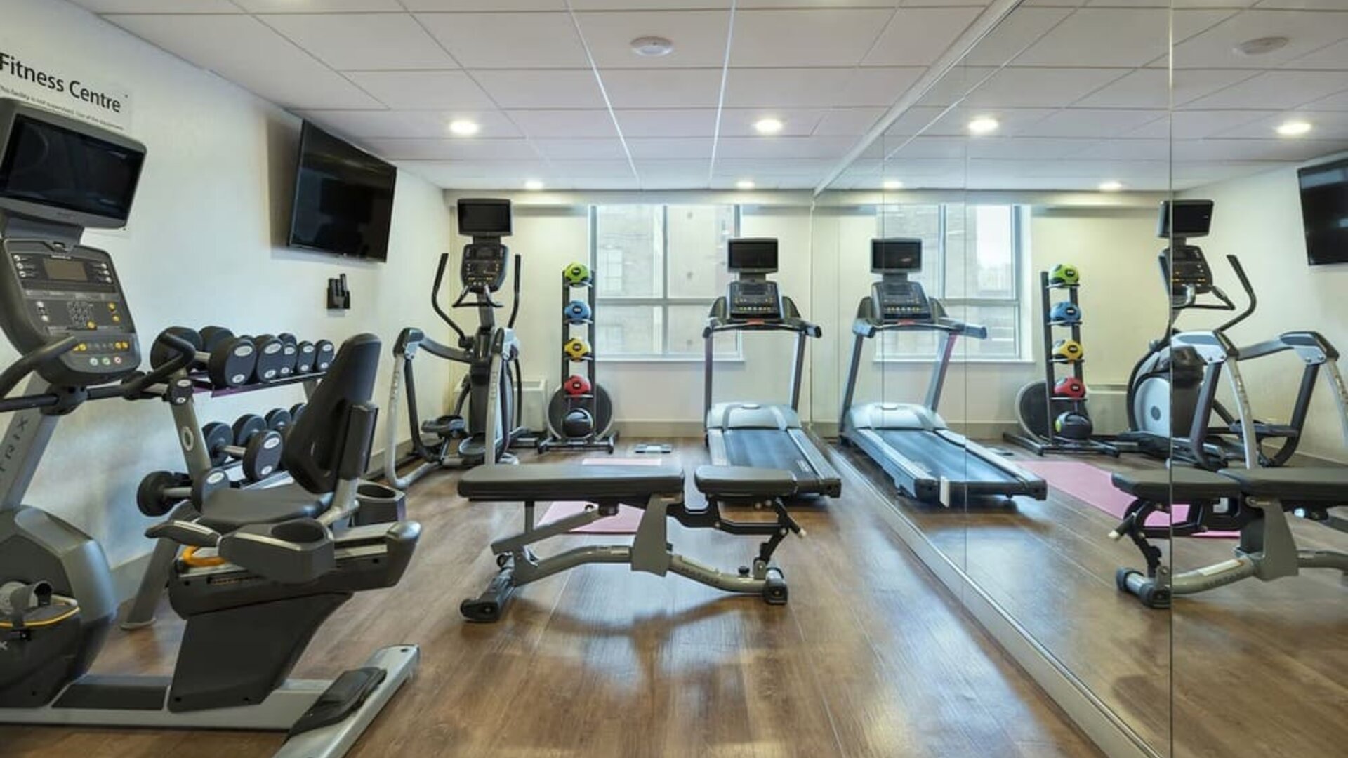 Well-equipped fitness center with cardio machines, free weights and strength training equipment at Holiday Inn Express Toronto Downtown.