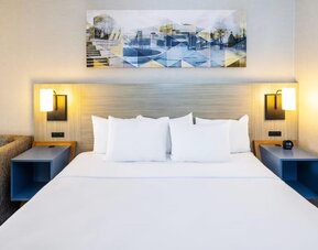 Inviting king bed with premium linens and modern bedside lighting for a restful stay at Comfort Inn Sydney.