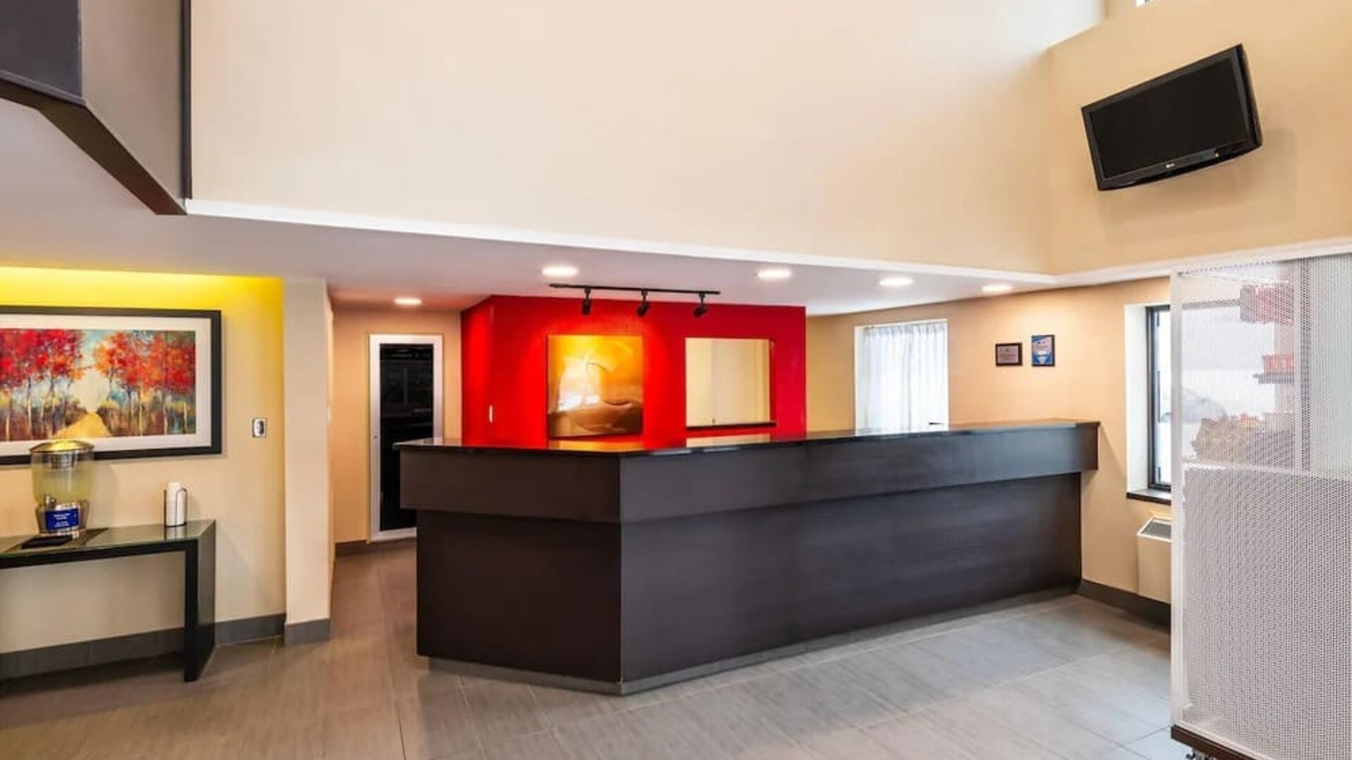 Spacious hotel lobby with modern reception desk, comfortable seating, and bright open design at Comfort Inn Amherst.
