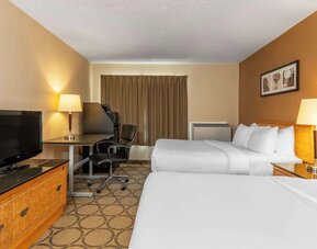 Guest room with two comfortable queen beds, ergonomic workspace, flat-screen TV, and modern amenities at Comfort Inn Thetford Mines.