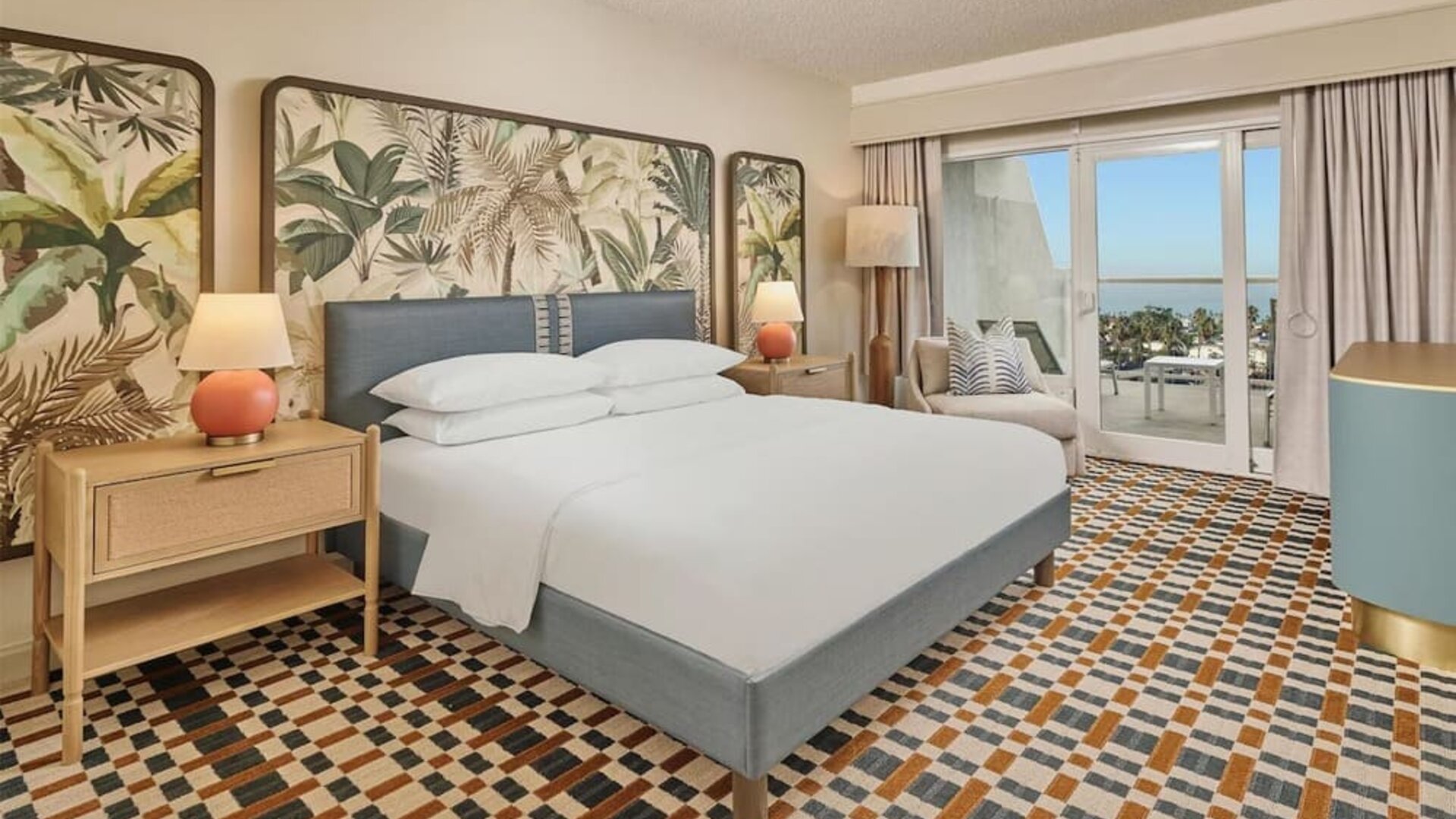 Elegant king guest room featuring plush bedding, private balcony, modern furnishings, and relaxing coastal-inspired décor at Hyatt Centric Delfina Santa Monica.