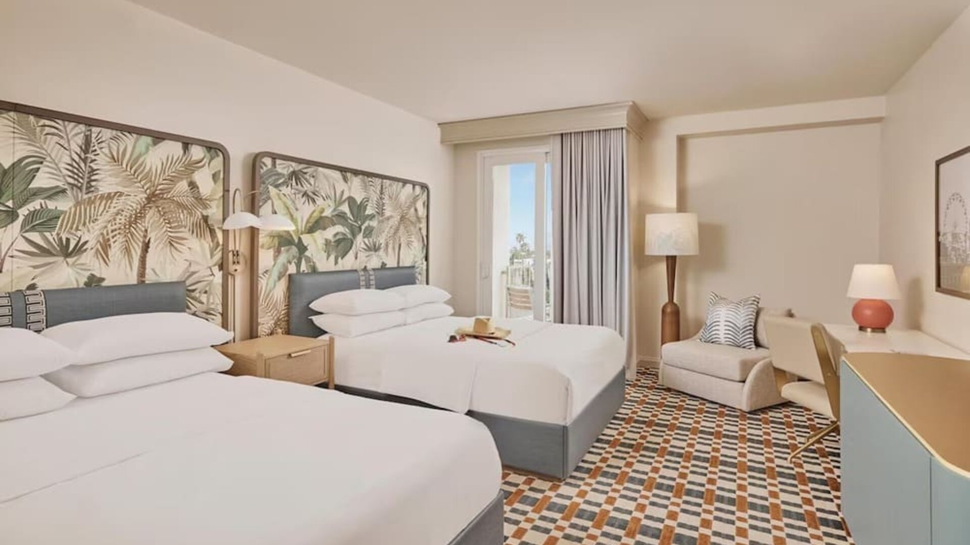Bright guest room with two comfortable beds, private balcony, ergonomic workspace, and contemporary coastal-inspired furnishings at Hyatt Centric Delfina Santa Monica.