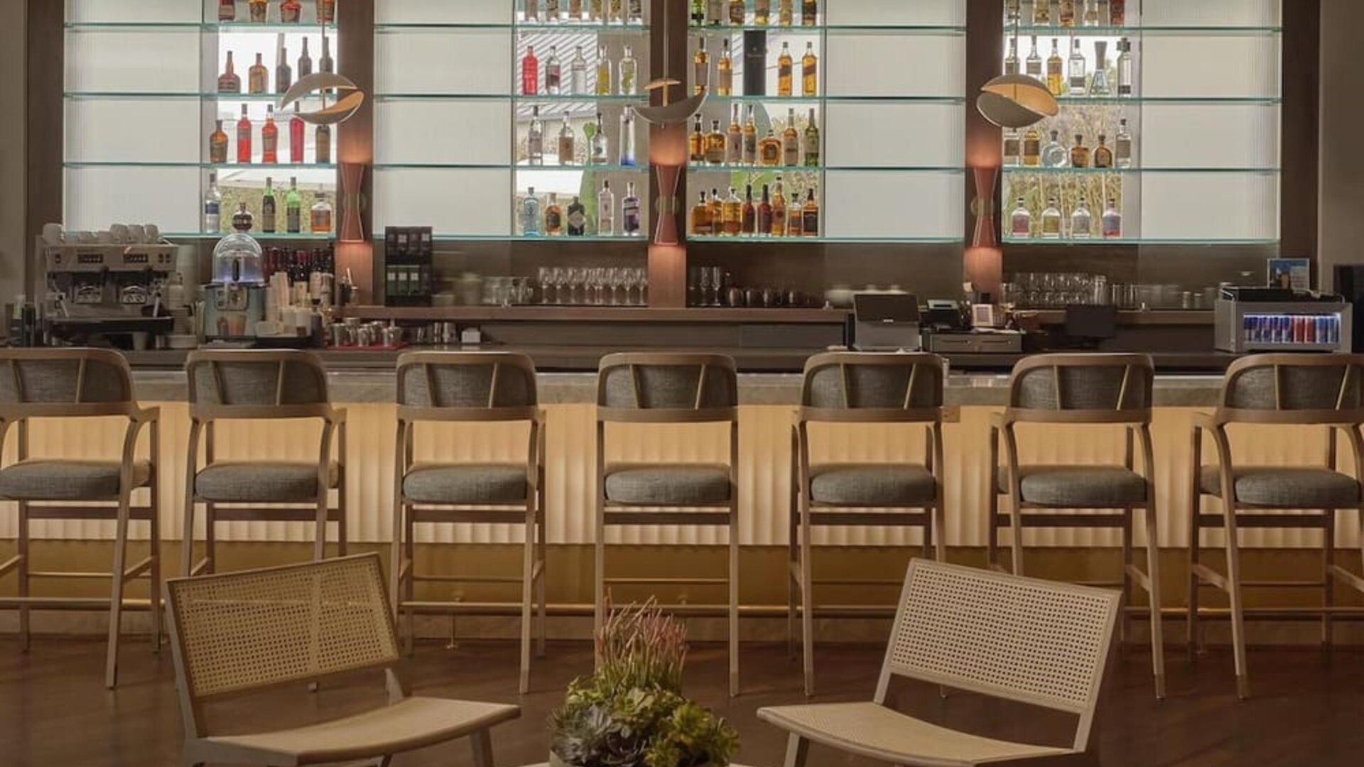 Modern hotel bar serving handcrafted cocktails, wine, beer, and light bites in a sophisticated lounge setting at Hyatt Centric Delfina Santa Monica.
