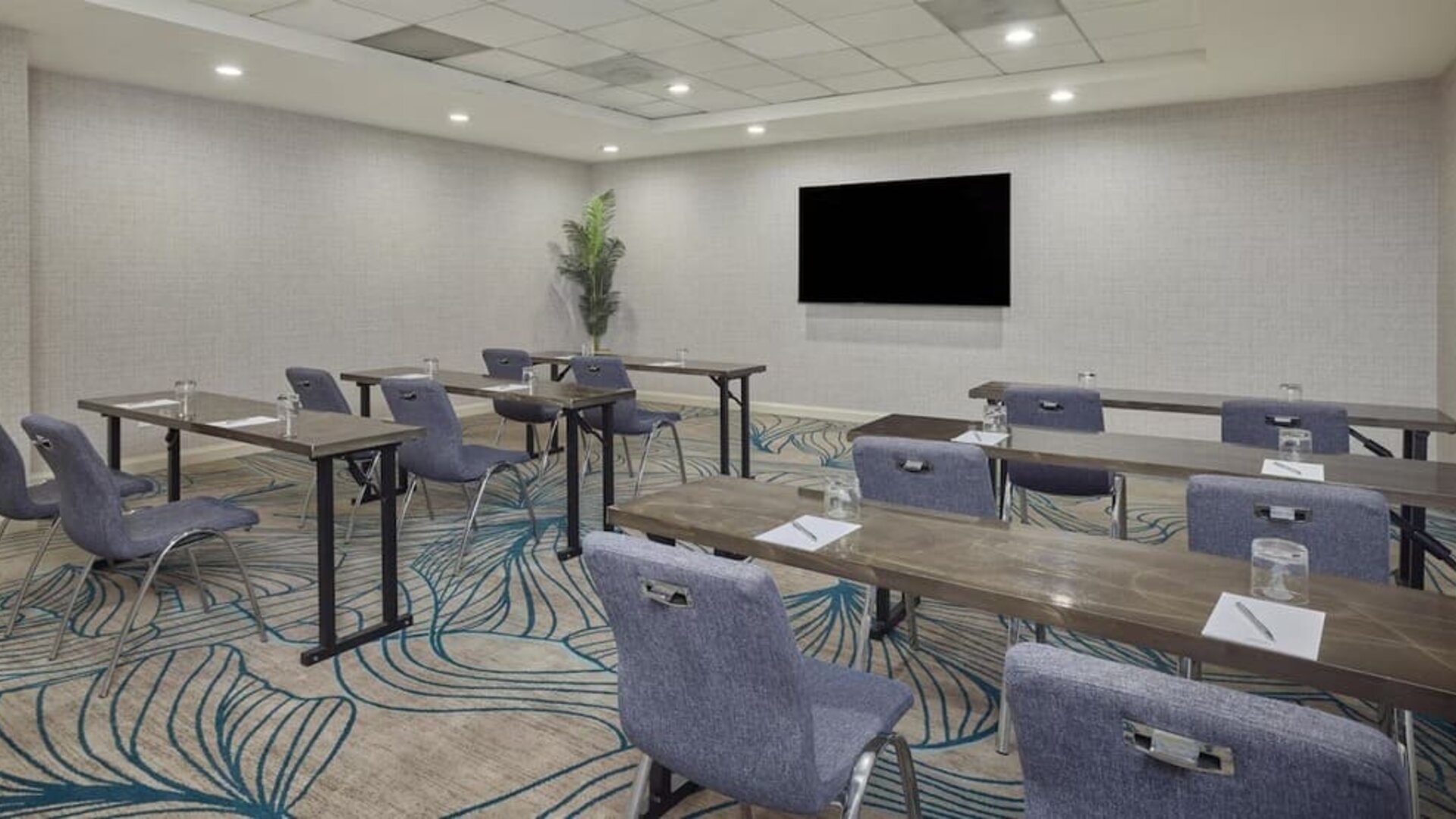 Modern meeting room equipped with audiovisual capabilities, comfortable seating, and flexible layouts for productive business events at Hyatt Centric Delfina Santa Monica.