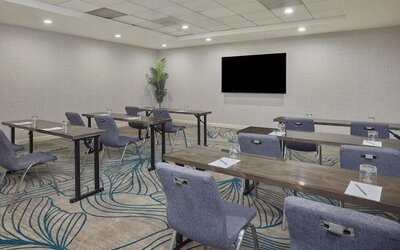 Modern meeting room equipped with audiovisual capabilities, comfortable seating, and flexible layouts for productive business events at Hyatt Centric Delfina Santa Monica.