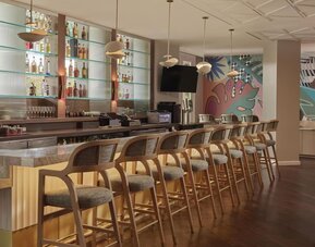 Contemporary hotel bar featuring handcrafted cocktails, premium spirits, and stylish seating in a vibrant social atmosphere at Hyatt Centric Delfina Santa Monica.