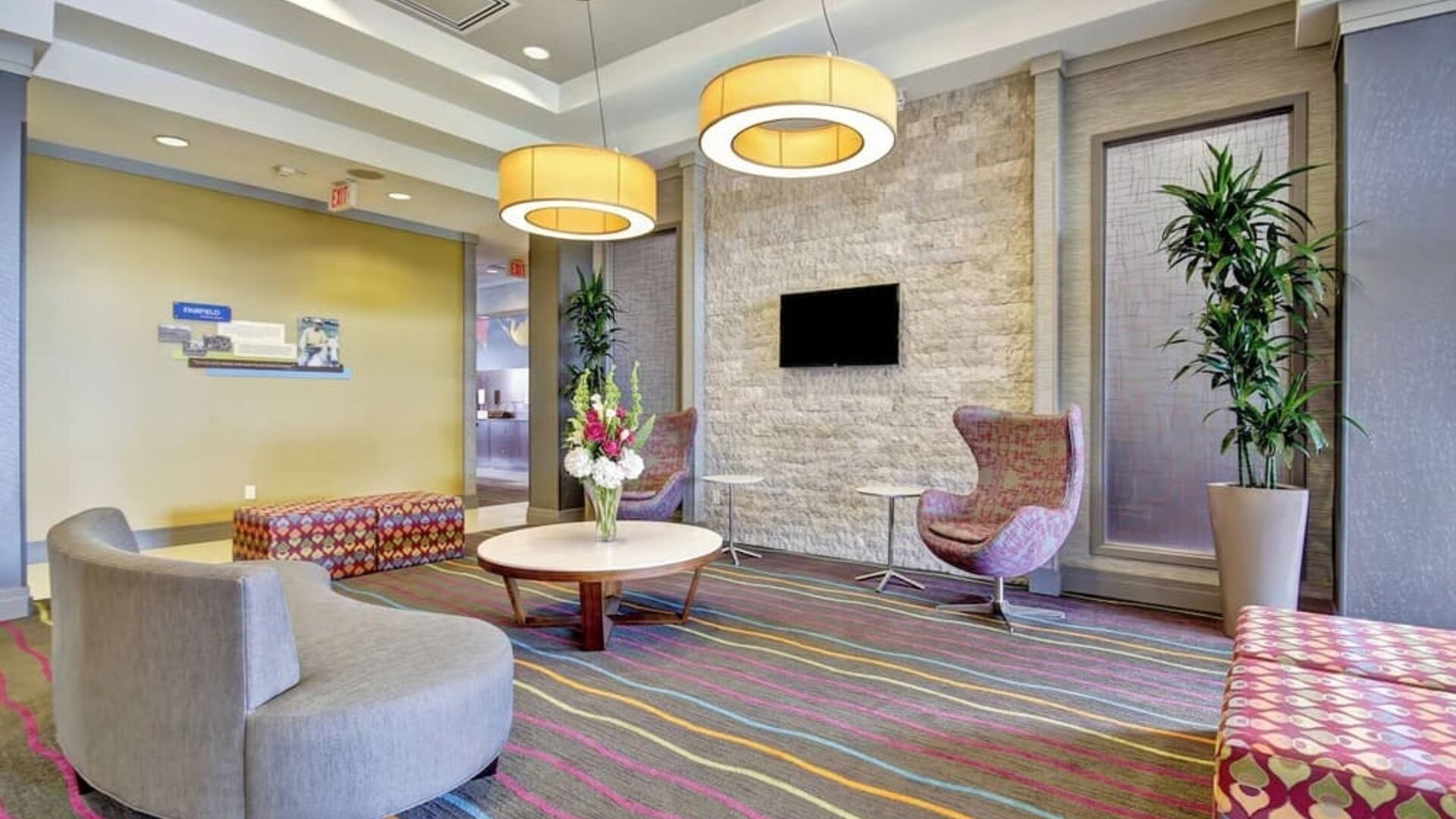 Stylish hotel lobby with comfortable seating, modern lighting, and a welcoming atmosphere at Fairfield Inn & Suites Guelph.