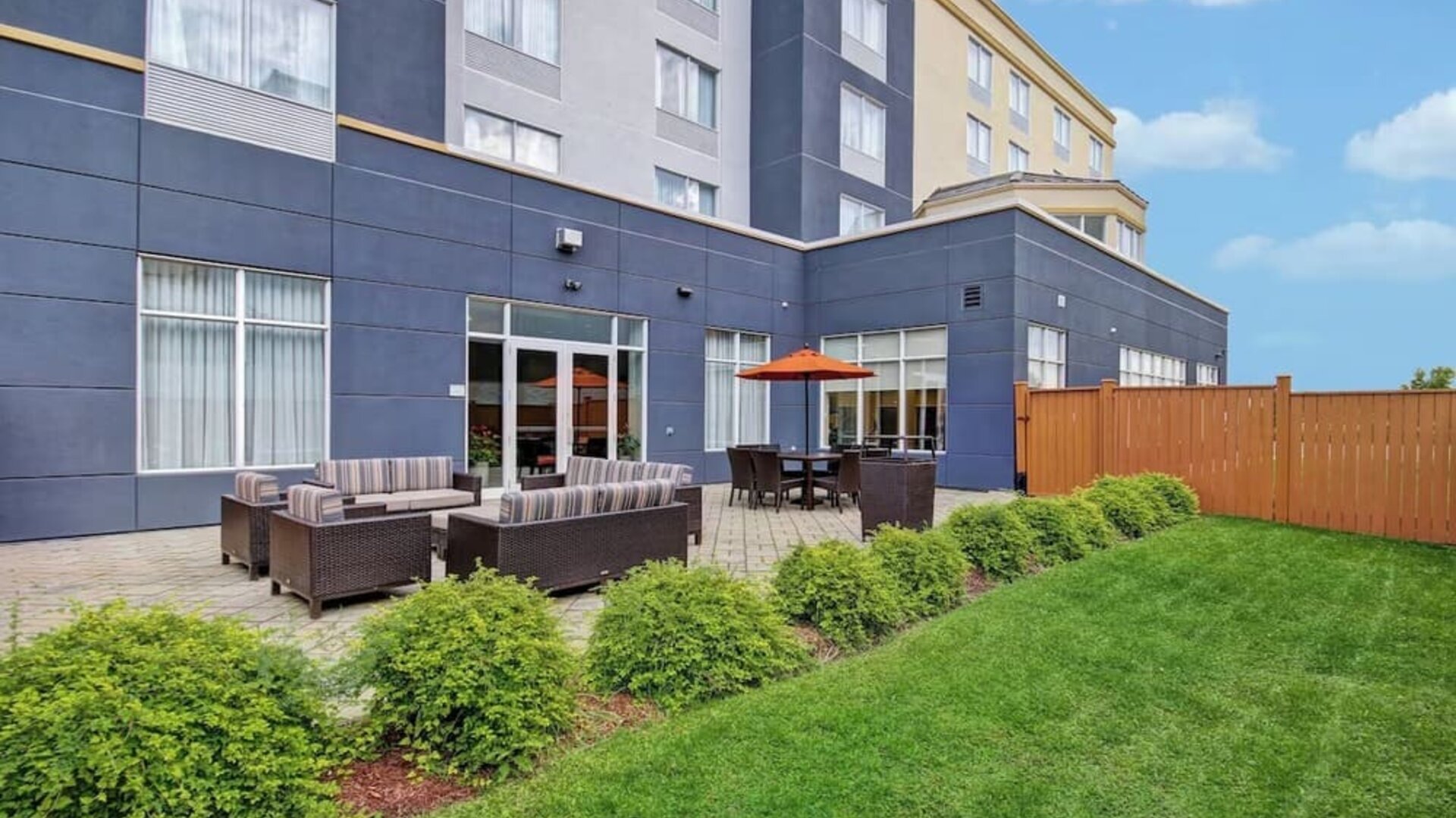 Outdoor patio with comfortable lounge seating and landscaped surroundings at Fairfield Inn & Suites Guelph.