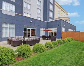 Outdoor patio with comfortable lounge seating and landscaped surroundings at Fairfield Inn & Suites Guelph.
