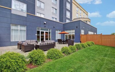 Outdoor patio with comfortable lounge seating and landscaped surroundings at Fairfield Inn & Suites Guelph.