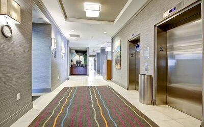 Modern hotel corridor with elevator access and contemporary interior design at Fairfield Inn & Suites Guelph.