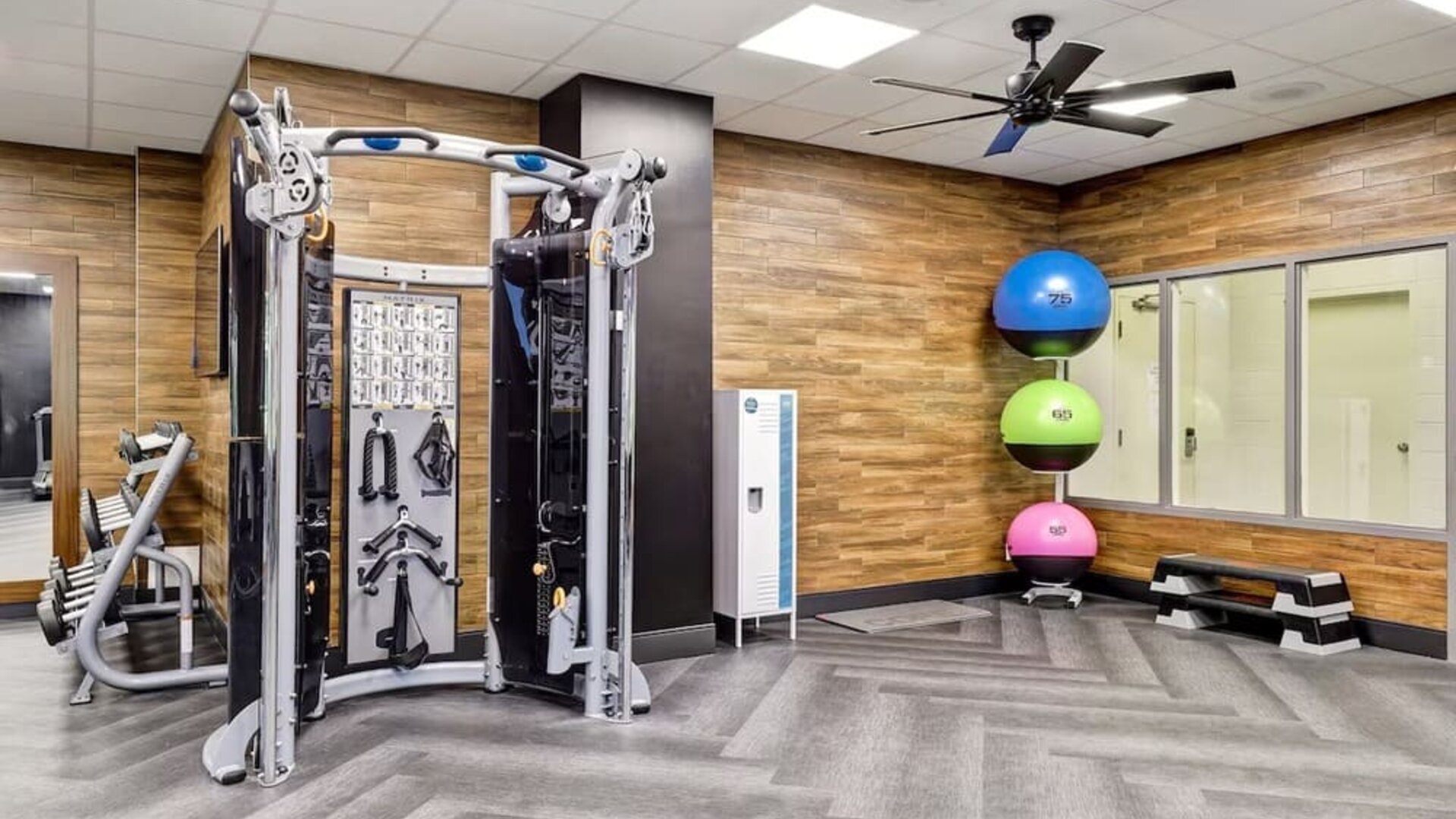 Fully equipped fitness centre featuring strength training equipment and functional workout space at Four Points by Sheraton St. Catharines Niagara Suites.