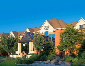 Exterior view of Four Points by Sheraton St. Catharines Niagara Suites with landscaped grounds and welcoming entrance.