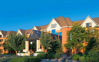 Exterior view of Four Points by Sheraton St. Catharines Niagara Suites with landscaped grounds and welcoming entrance.