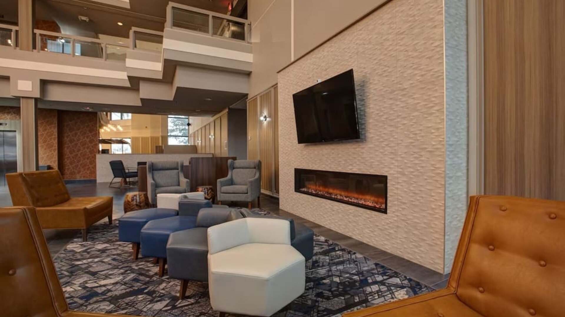 Cozy lobby lounge featuring a fireplace, comfortable seating, and a relaxing atmosphere at Four Points by Sheraton St. Catharines Niagara Suites.