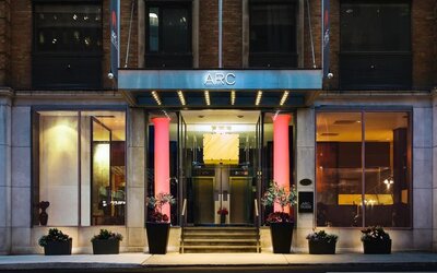 Elegant hotel entrance with contemporary architecture and a welcoming illuminated façade at ARC The Hotel Ottawa.