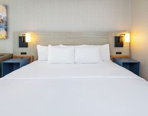 Close-up view of the plush king bed with premium linens for a restful night's sleep at Comfort Inn Airport East Ancienne-Lorette.