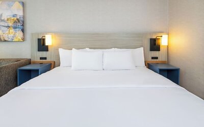 Close-up view of the plush king bed with premium linens for a restful night's sleep at Comfort Inn Airport East Ancienne-Lorette.