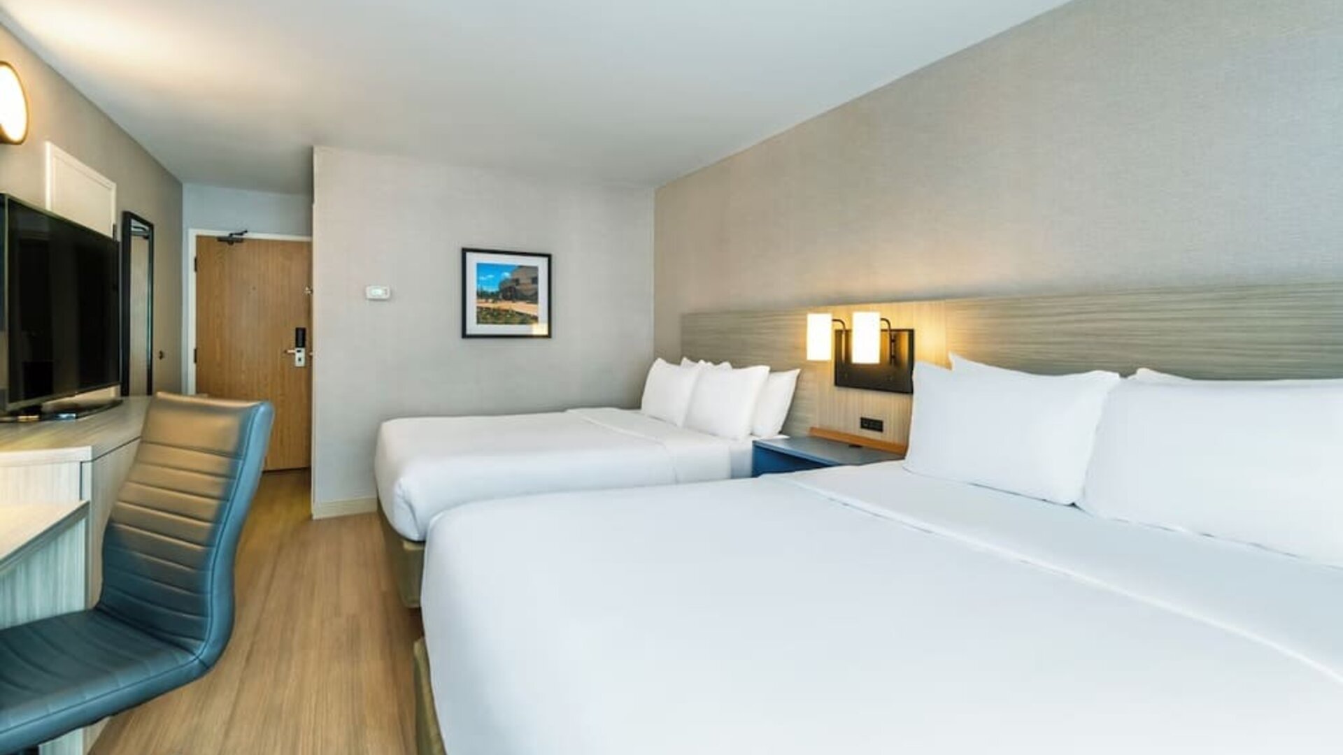 Modern guest room with two queen beds, comfortable bedding, and ample space for families or groups at Comfort Inn Airport East Ancienne-Lorette.